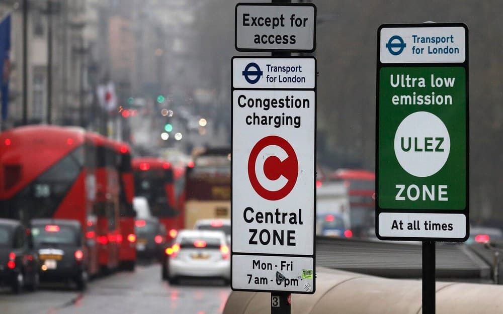 TfL Congestion Charge and ULEZ signs beside London traffic