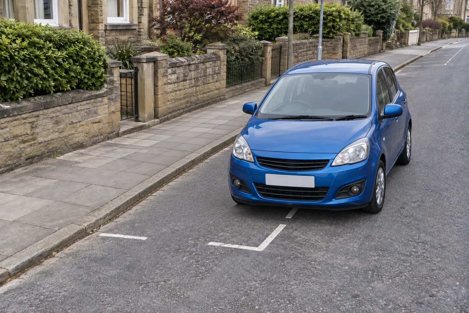 Car straddling the outer white boundary of an ordinary on-street parking bay.