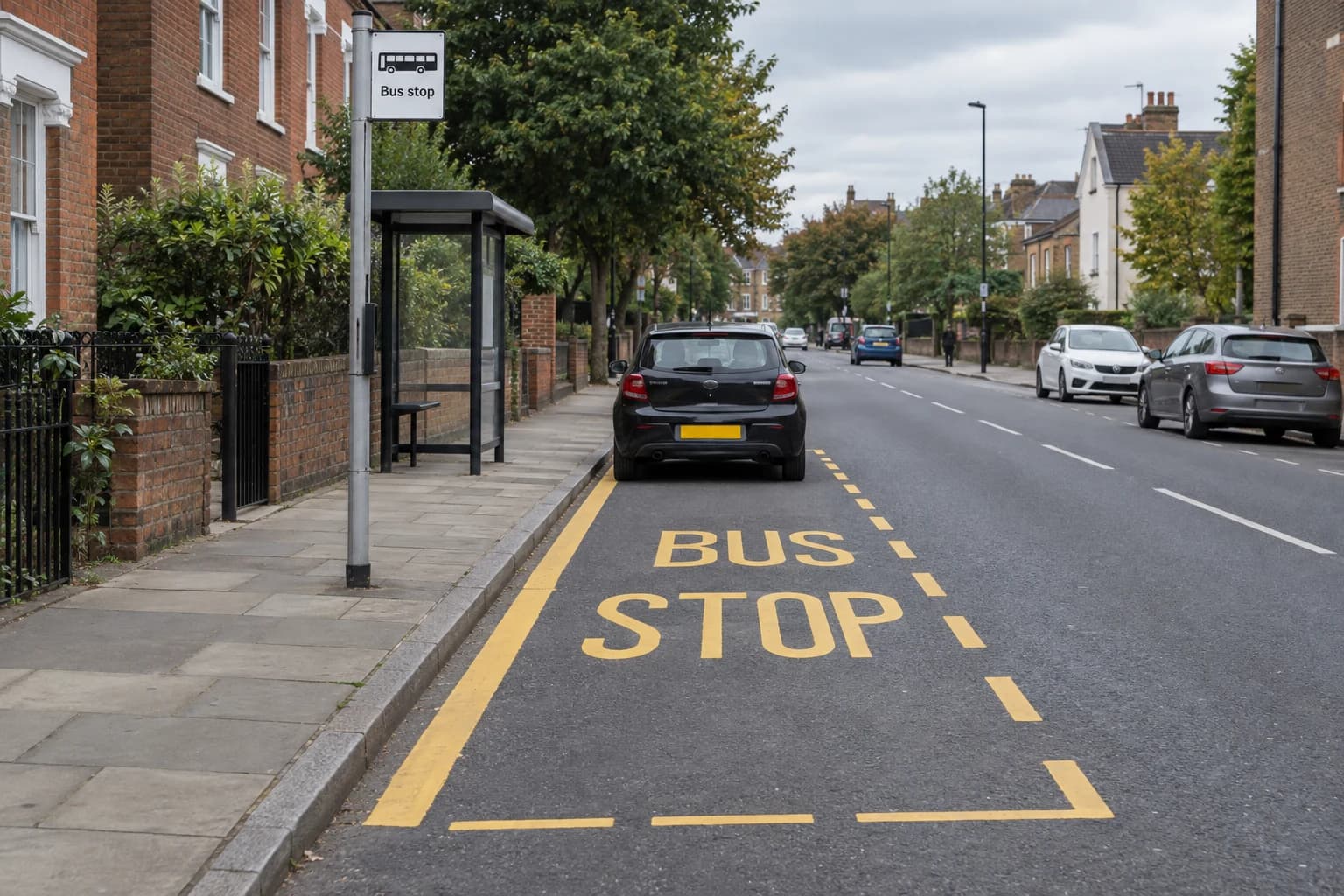 Car within a yellow bus-stop cage marked BUS STOP beside a bus-stop sign.