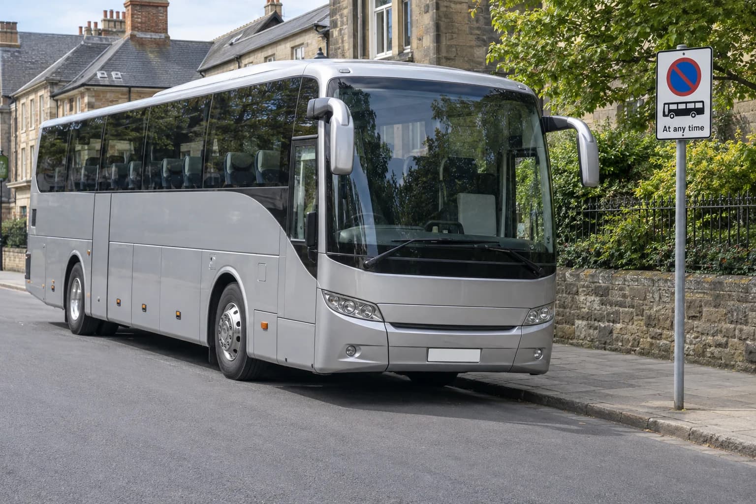 Full-size coach waiting beside a kerb near a bus-specific waiting restriction plate.