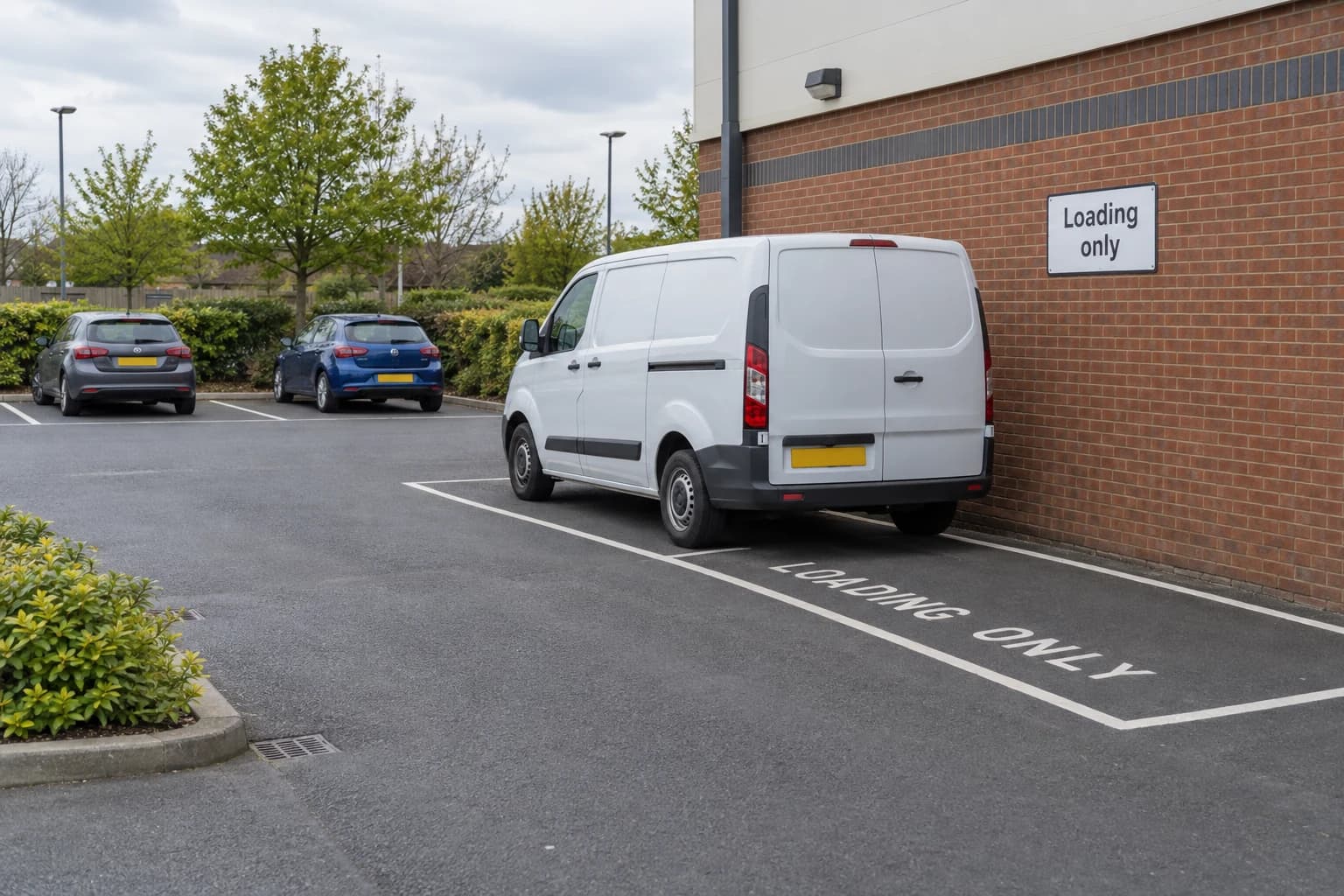 Van in a designated loading-only area inside an off-street car park.