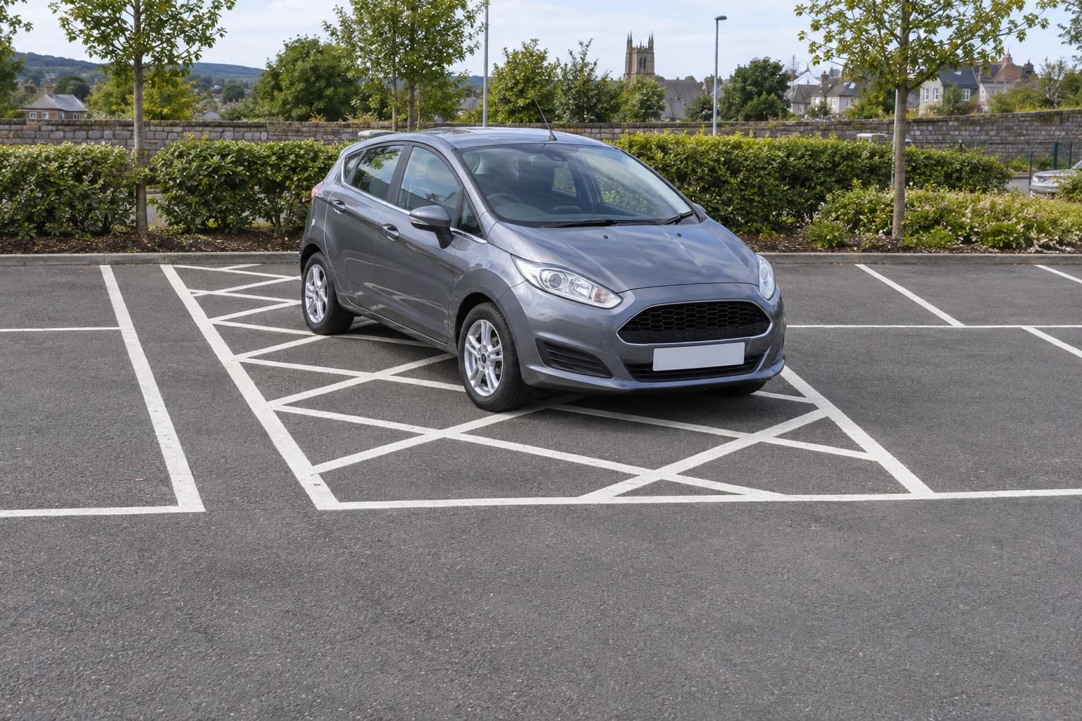 Illustrative car parked over a white hatched restricted area between car-park bays
